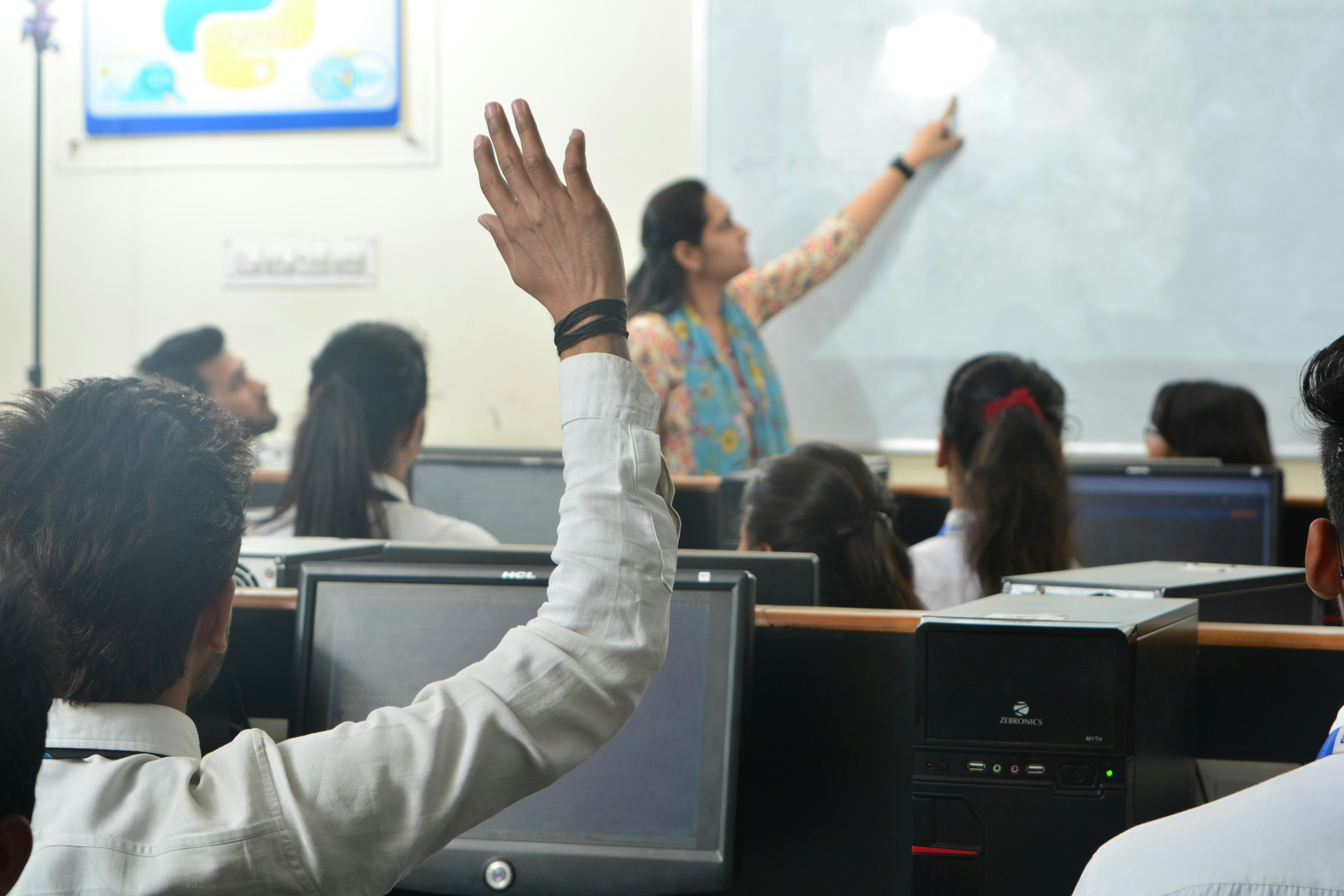 Instructor guiding students through a computer lab exercise